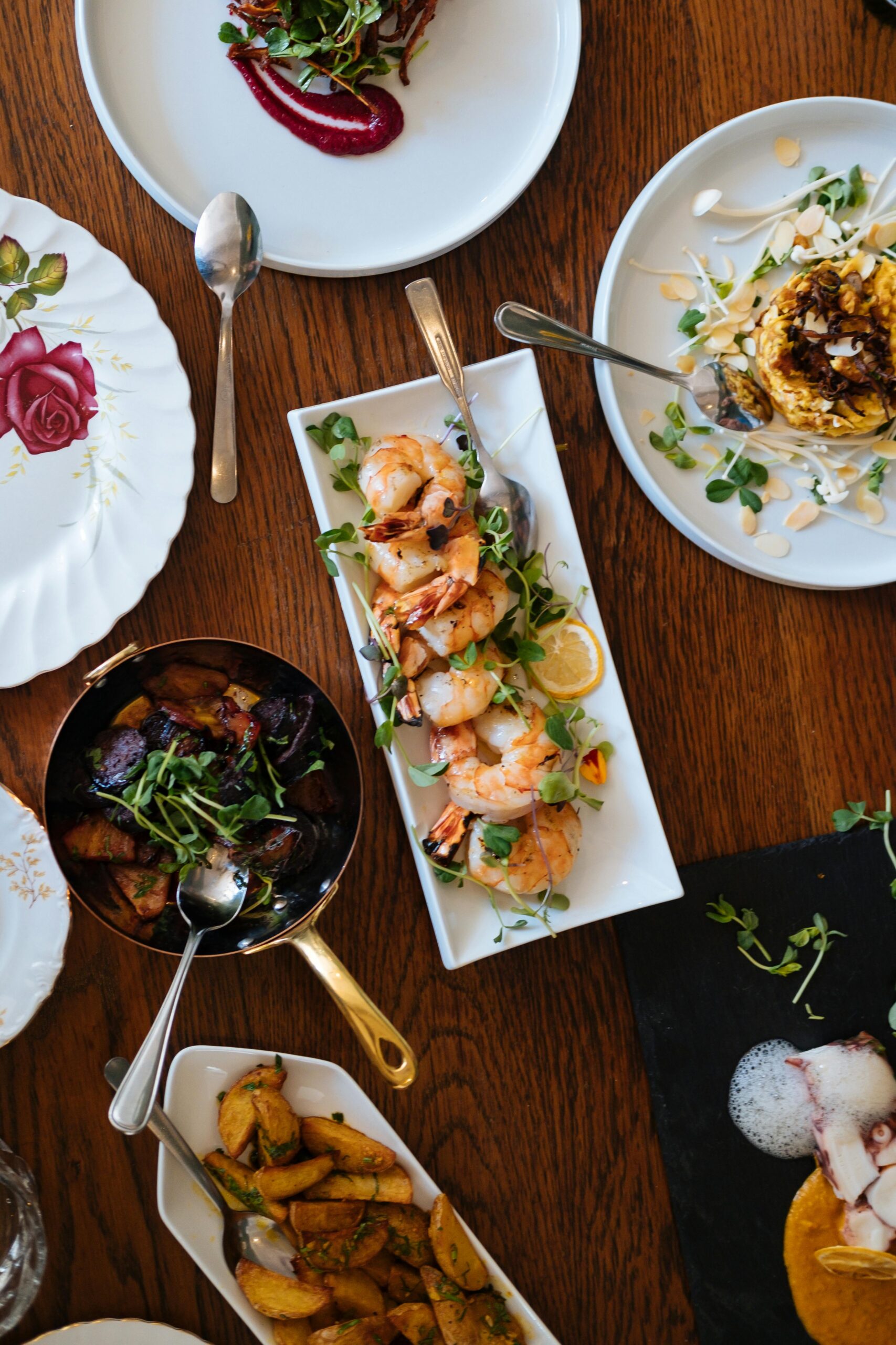 An overhead view of a beautifully arranged dining table featuring various gourmet dishes, perfect for a culinary experience.